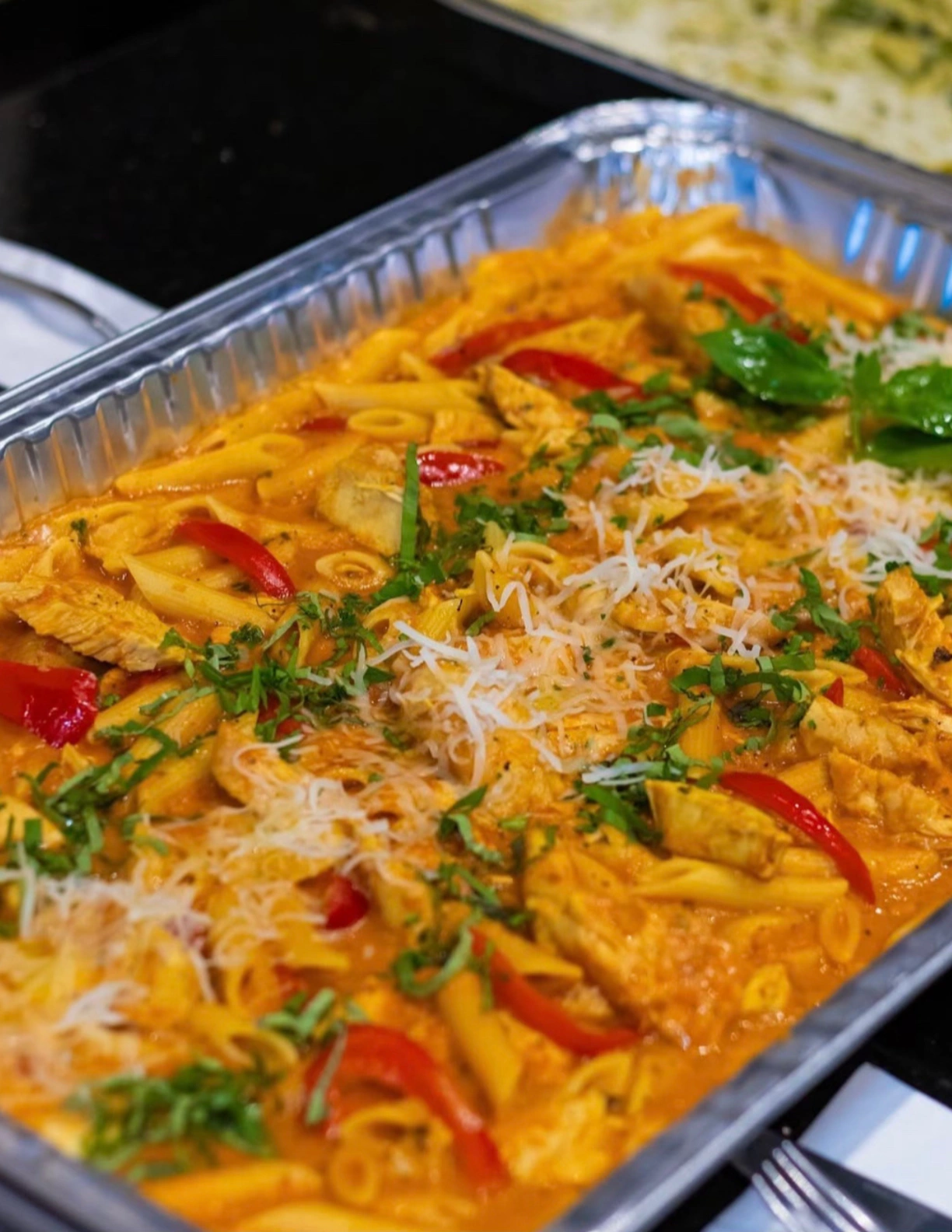 pasta made in sauce and topped with cheese and parsley